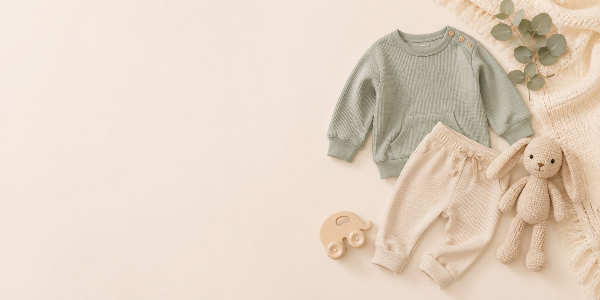 Children's green sweatshirt and beige shorts with a teddy bear on a beige background